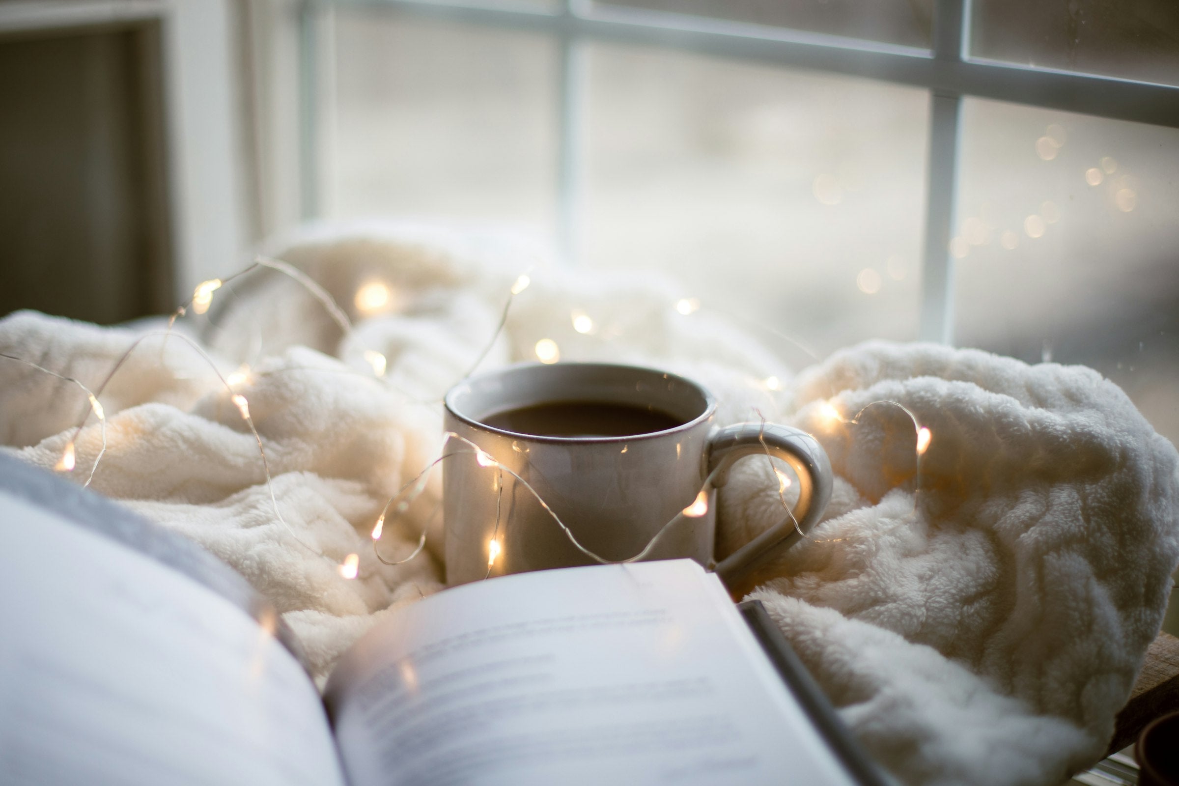 Cozy tea and book by the window - Quill Guides
